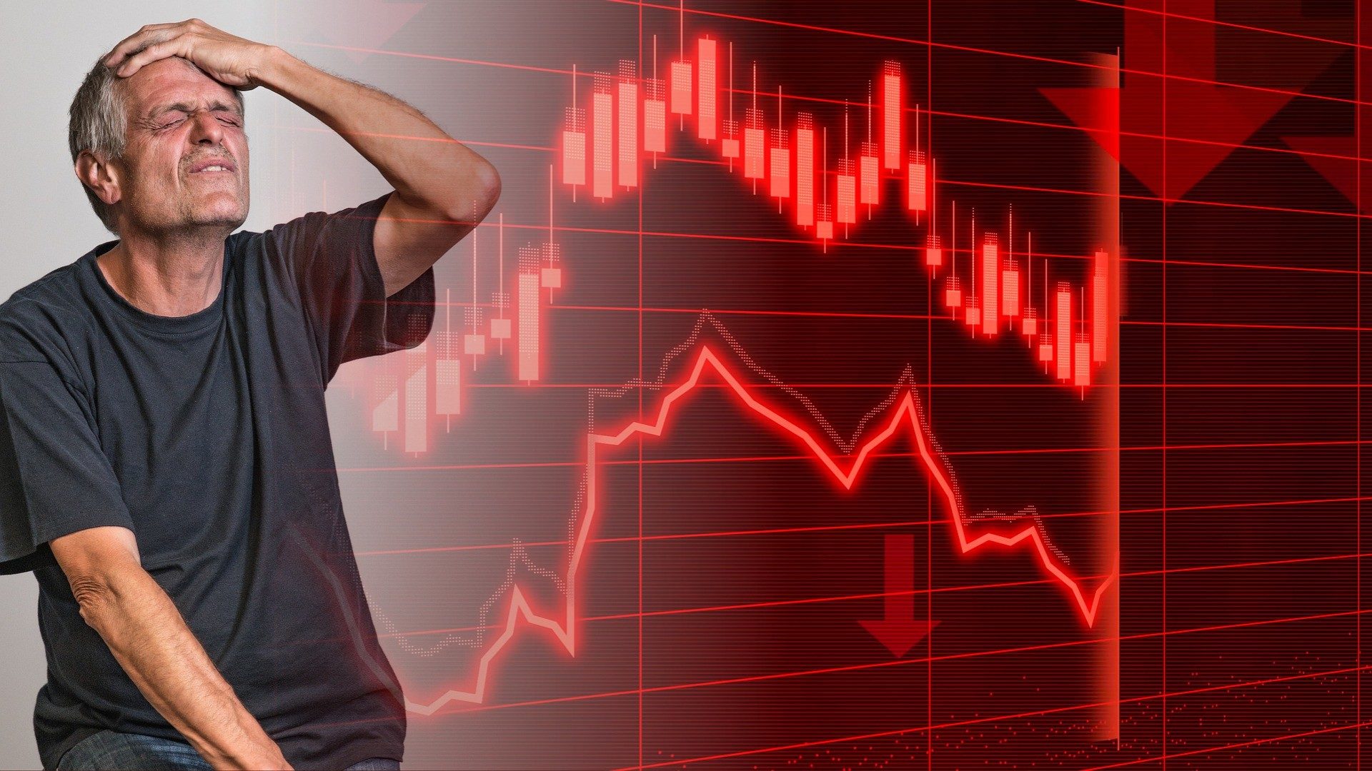 Ein älterer Mann ärgert sich vor einem tiefroten Aktien-Chart über einen Verlust