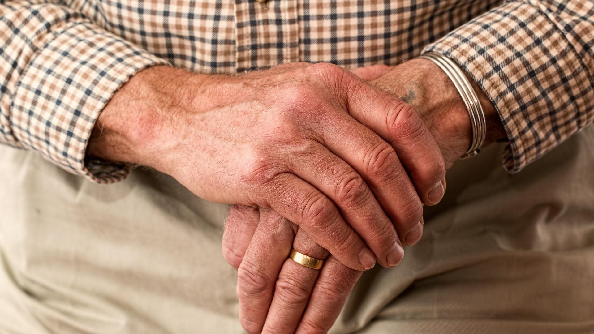 Eine alte Person im Ruhestand faltet die Hände