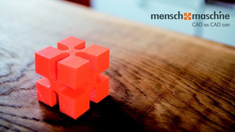 Ein orangeroter Würfel, der das Logo des CAD-Unternehmens Mensch und Maschine imitiert