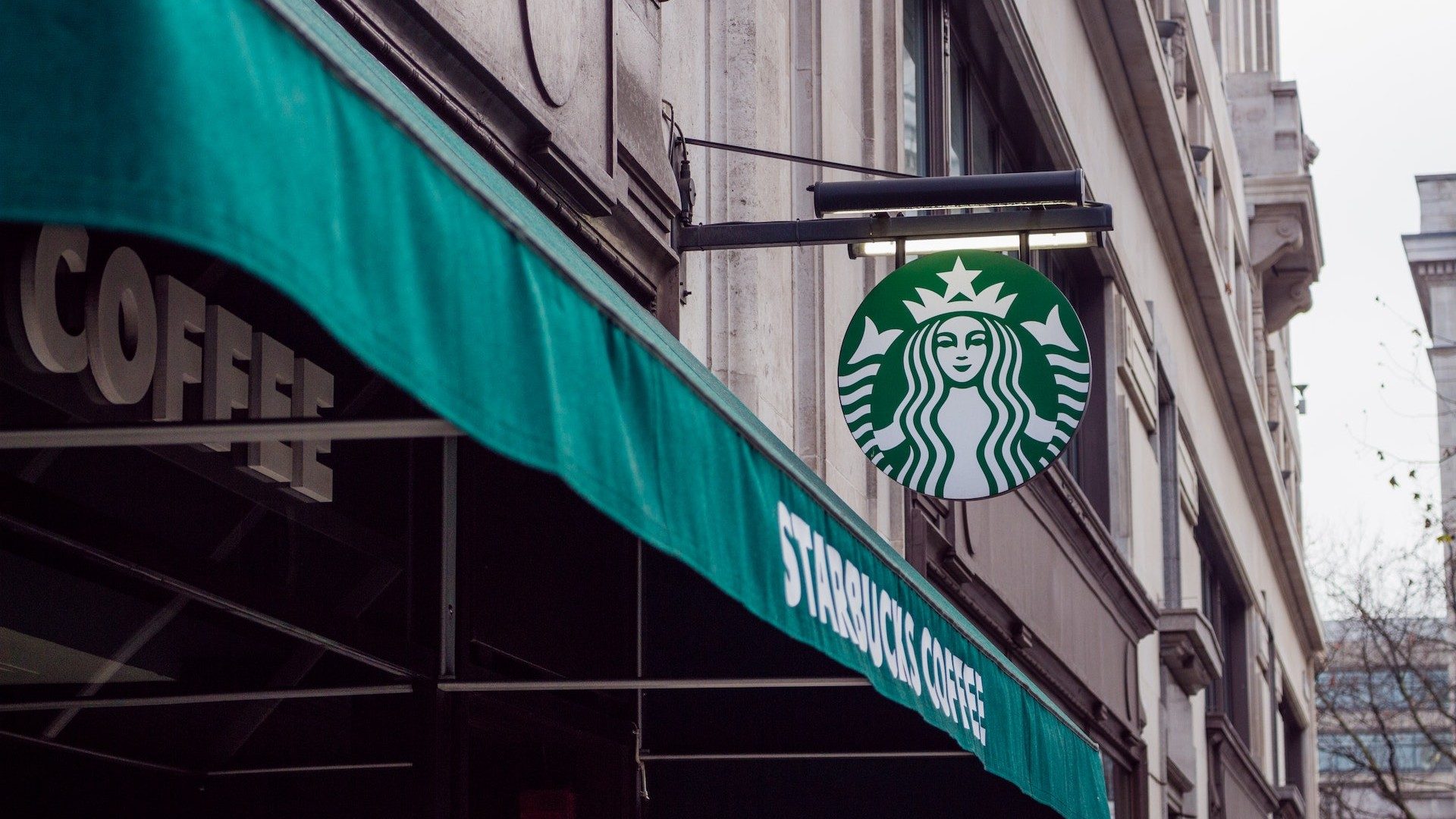 Logo und Schriftzug an einer Filiale der Kaffeekette Starbucks