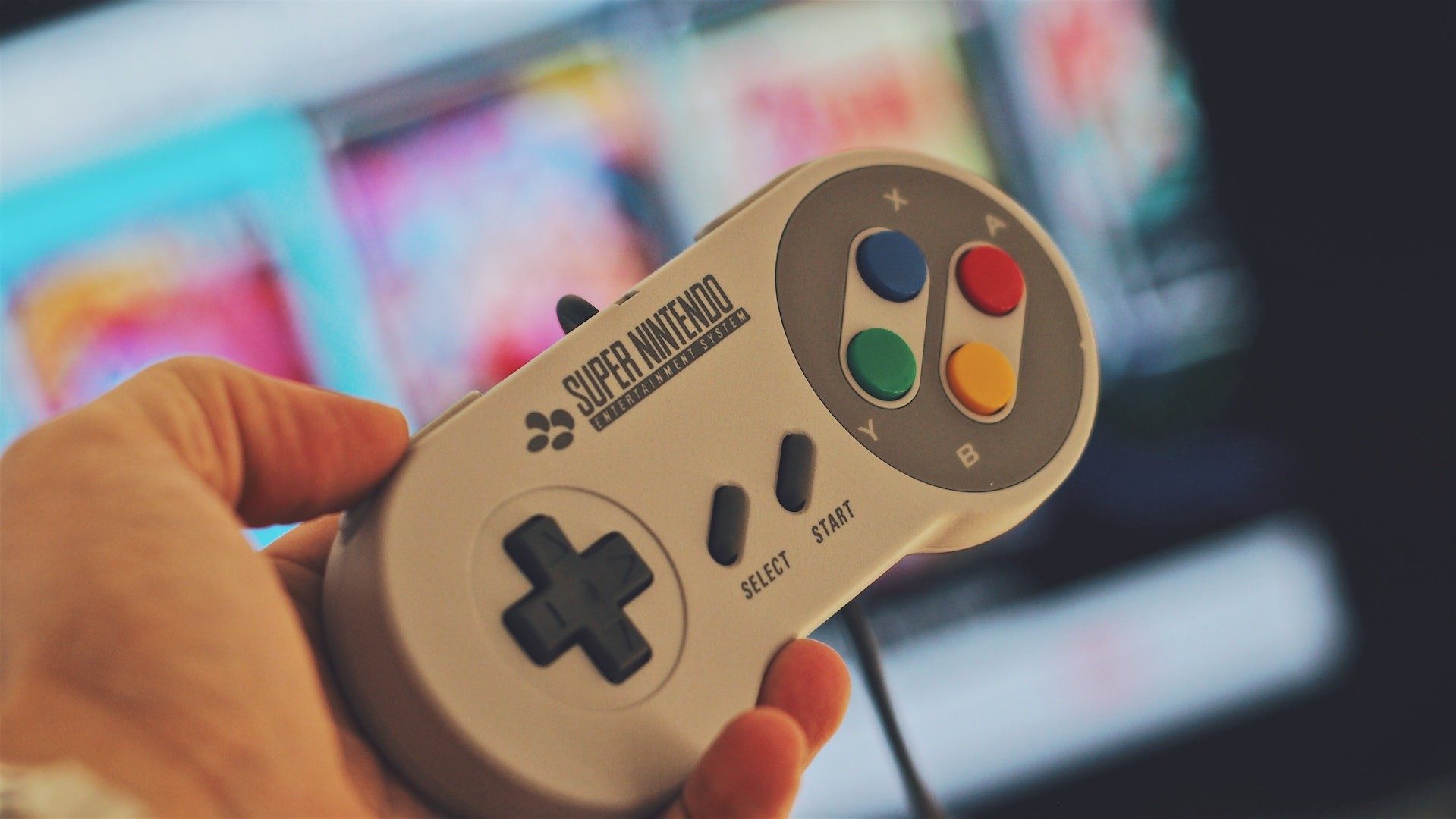 Eine Person hält einen SNES-Controller des Videospiele-Unternehmens Nintendo