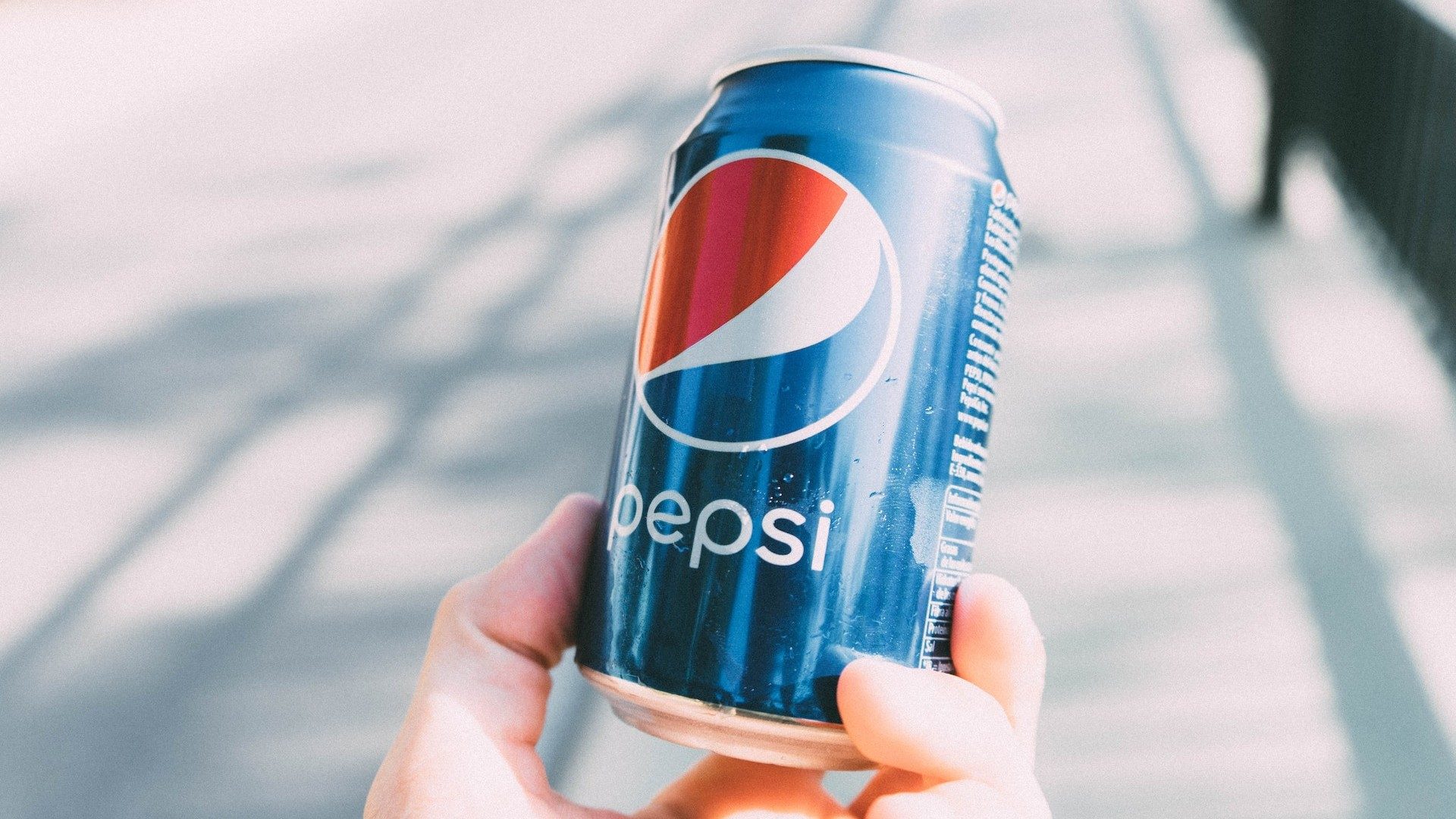 Eine Person hält eine Pepsi-Cola-Dose