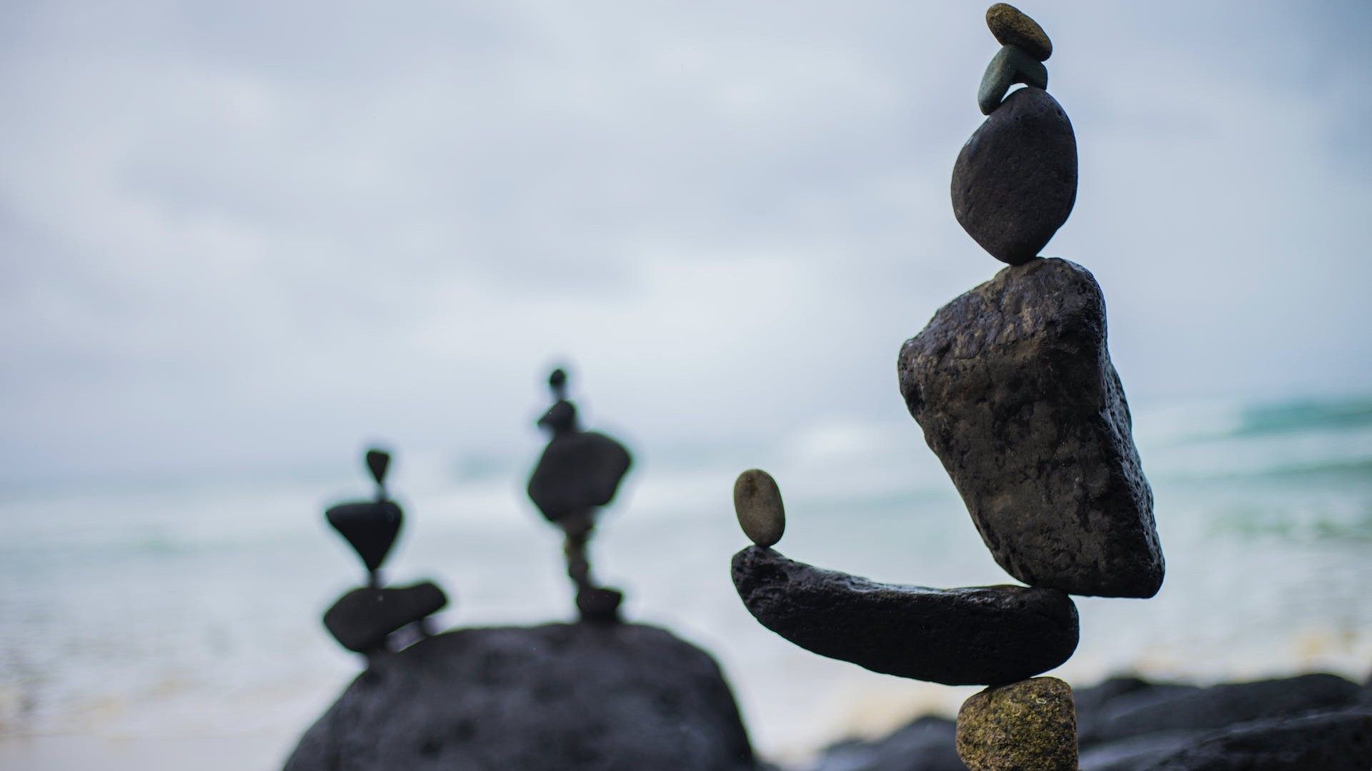 Steine am Meer stehen in perfekter Balance aufeinander