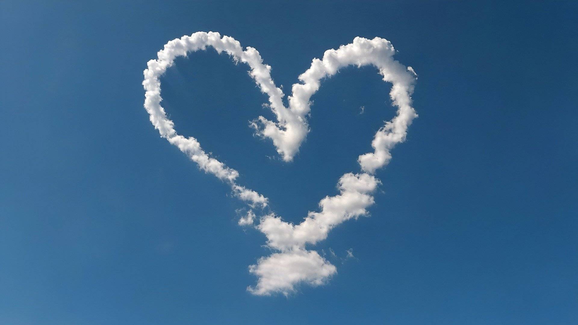 Ein Herz aus Wolken am blauen Himmel